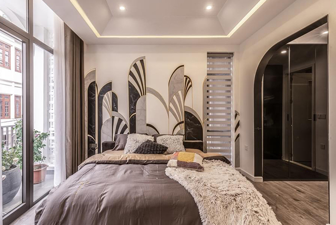 The main color tone of bedroom is white mixing with black in combination with tile floor and neutral color interior. Tracery highlights on the wall make the bedroom become lively. A big and high-to-ceiling glass door leads natural lights and wind into the room.