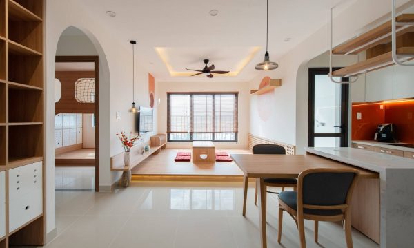 Main colors of apartment are sunset orange, wooden brown of interior and white of paint