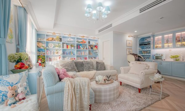 Living room is in a light theme and showing a cozy feeling. Baby blue tone is accentuated by striped interior.