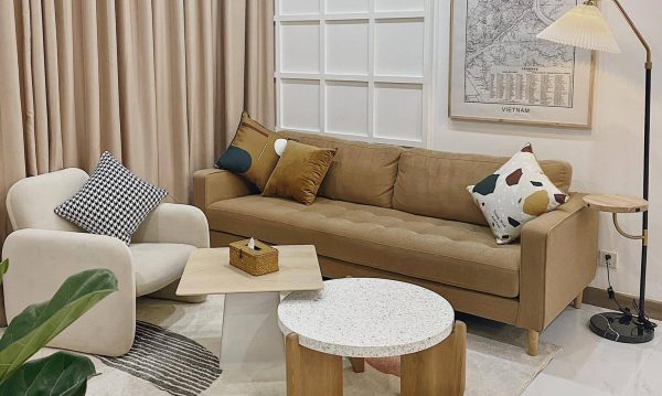 Brown felt sofa becomes a highlight in this bright living room. There are a lot of geometries using to design interior for the room creating a beautiful combination such as circle and square from two coffee table, trapezoid from a coffee table foot, squares from colorful cushions, rectangle from a beige armchair