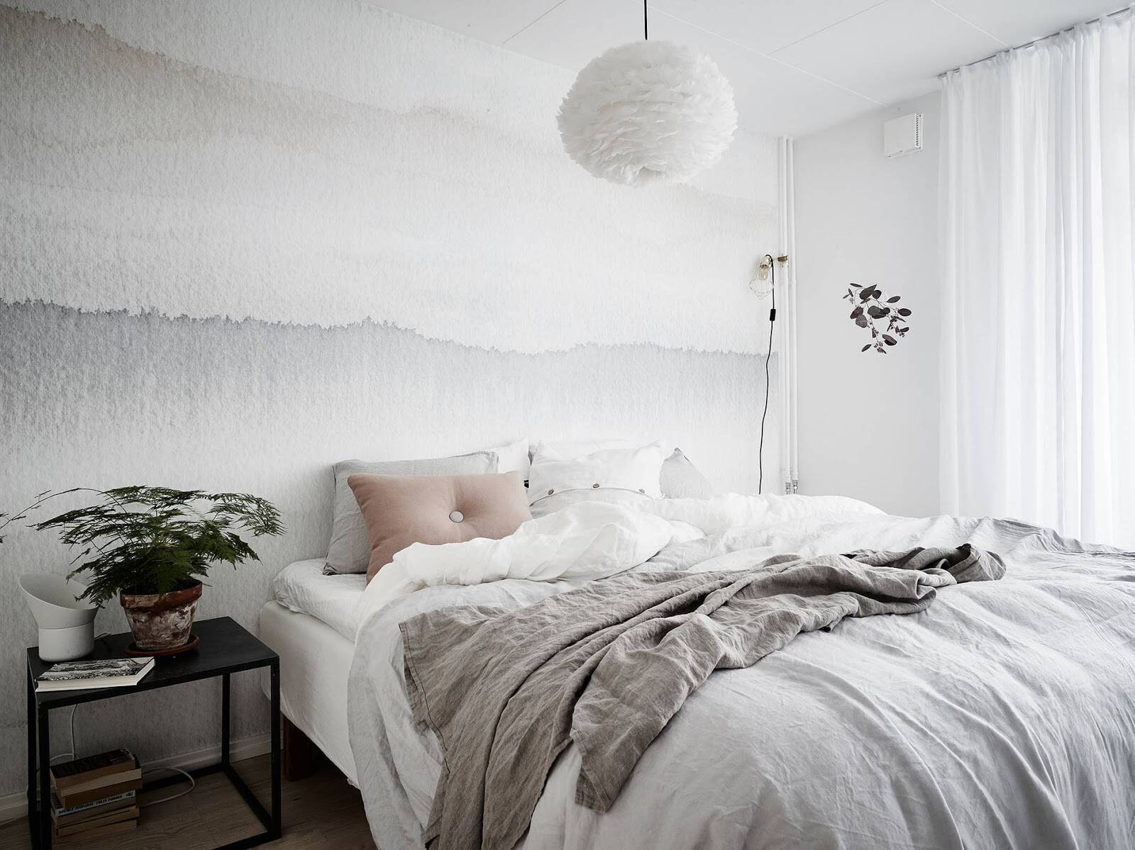 A Scandinavian bedroom is cozy, transparent, and sophisticated.