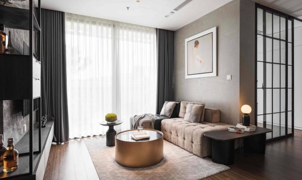 Luxurious and elegant living room with L-shaped velvet sofa, harmoniously coordinated with round tea table.