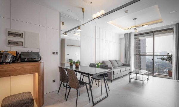 Gray is the main color of kitchen and living room interior starting from fabric sofa, fabric dining chair to the main wooden door.