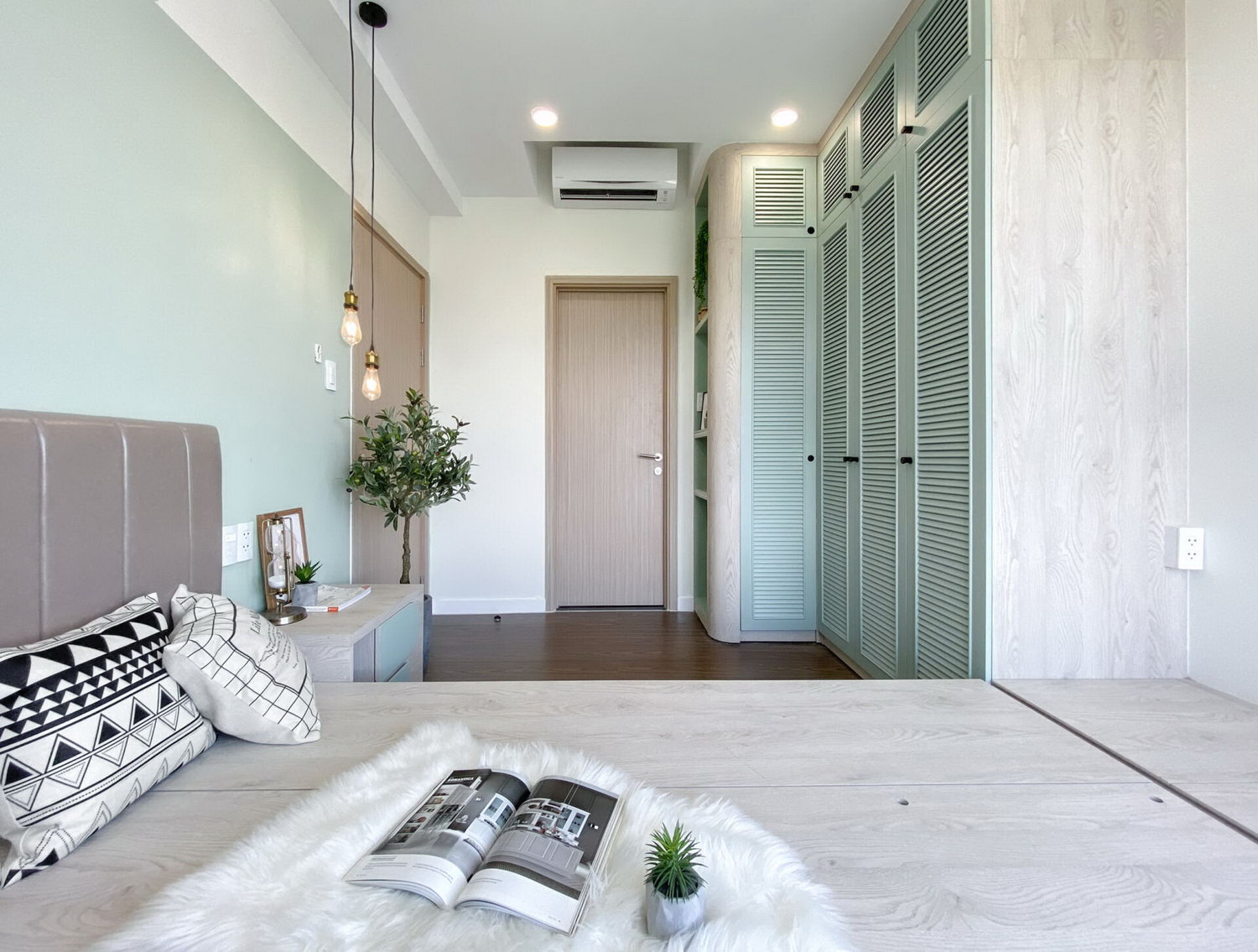 Mint green combined with white and light brown wood makes the room look larger.