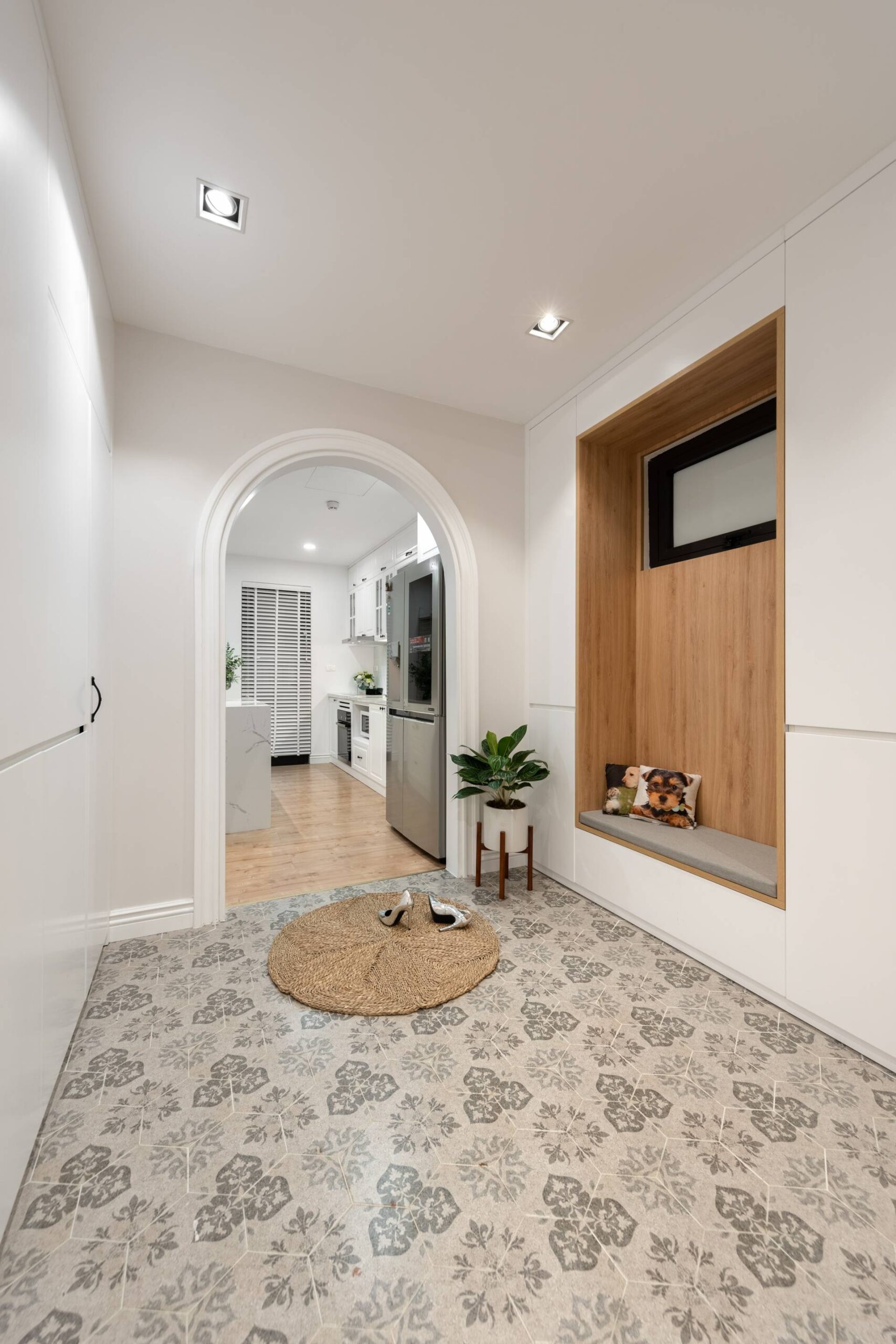 Arched door design is soft as a buffer before leading into the indoor space.