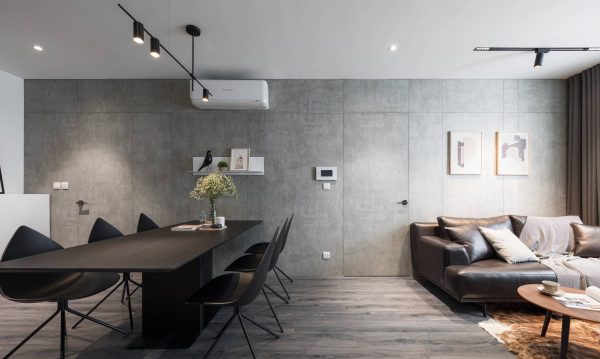 Extended concrete wall not only makes the home look longer, but also provides a solid foundation for loose furniture to put in.