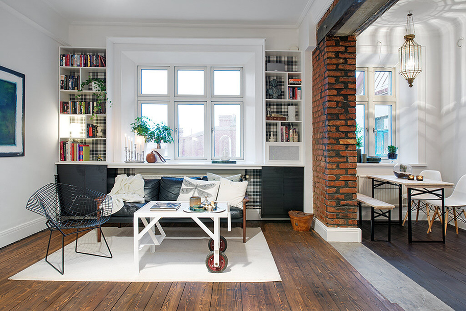 The natural-colored wooden floor goes well with the exposed brick wall.