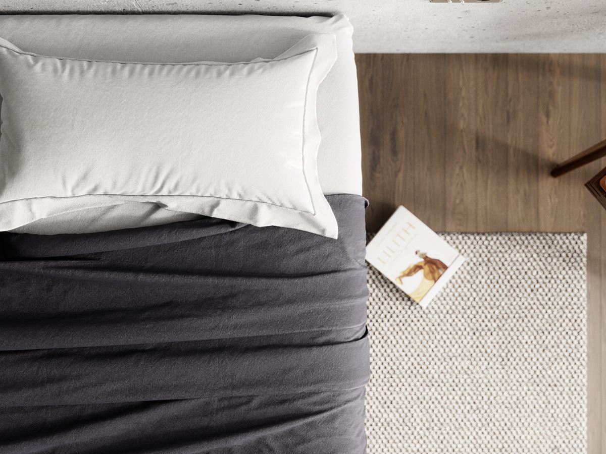 The carpet with gray and white color creates synchronization with the bed linen.