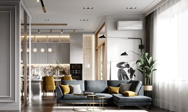 The living room is arranged next to the window to receive warm sunlight, and the yellow color of the sofa pillows creates an eye-catching accent for the space.