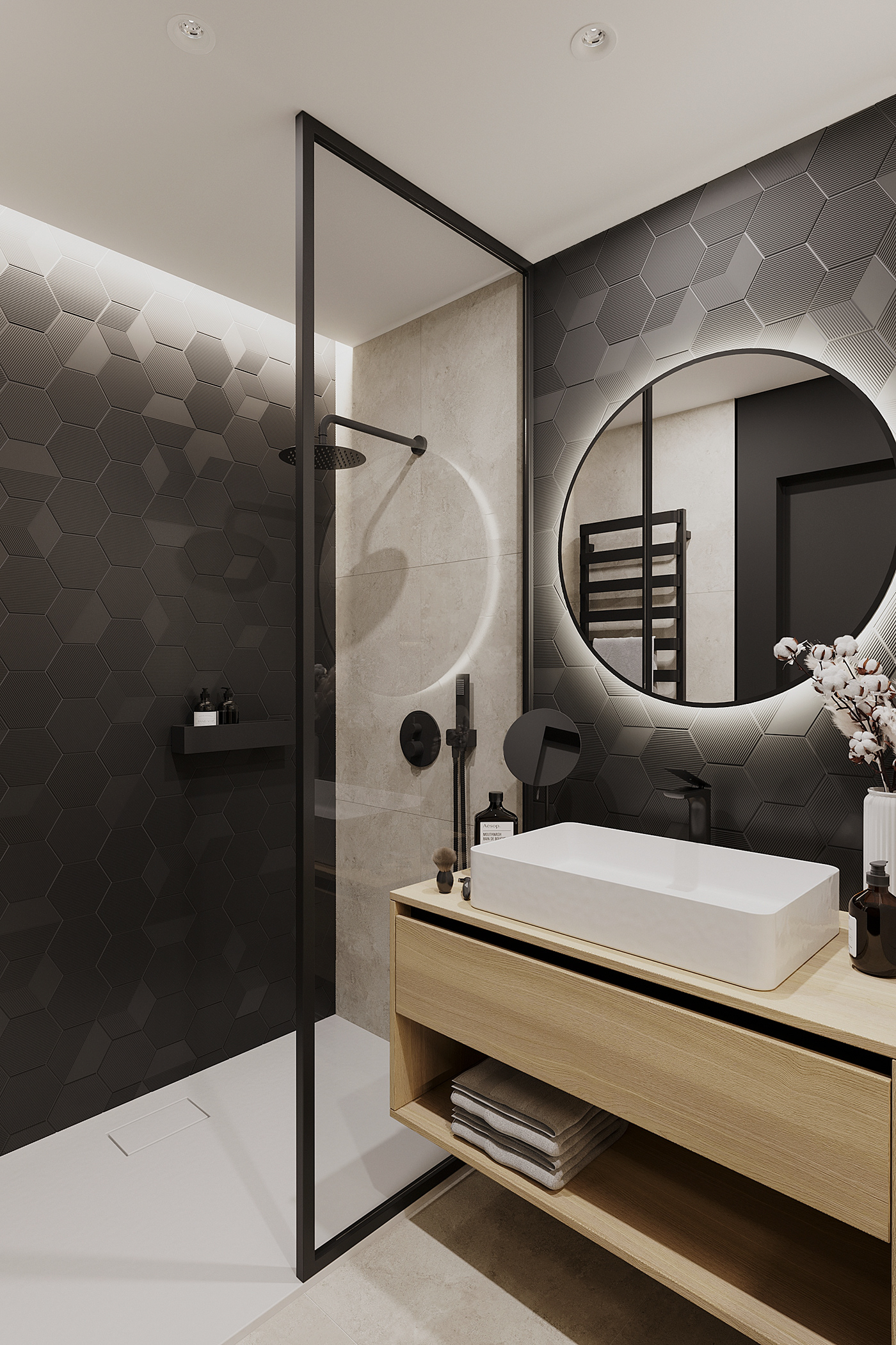 Honeycomb wall tiles are a unique highlight of this bathroom's interior, while a circular mirror softens the space by balancing the sharp lines.