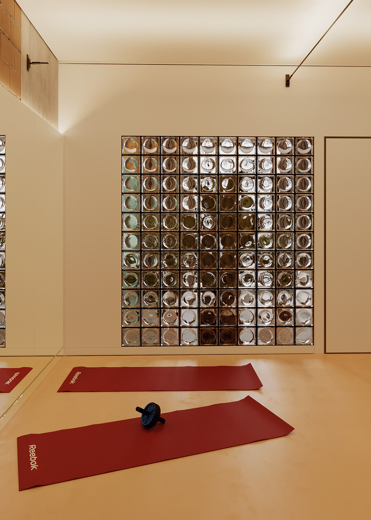 Red yoga mats contrast with the beige floor and walls. Every detail in this zone is highlighted by the lighting system.