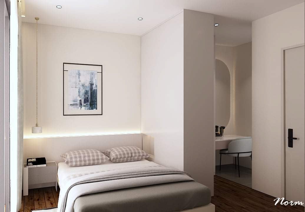Except for an art picture on its headboard wall, this simple minimalist bedroom is devoid of unnecessary decorative items. Natural light is reflected off the wall color, enveloping the space in a sense of relaxation and comfort. A small wall separates a preparation area, providing necessary privacy while also saving space.