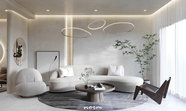The combination of neutral colors creates a pleasing visual effect. A soft, rounded sofa stands out on a dark gray rug, with a low, round wooden coffee table in the center, creating a soft and comfortable atmosphere.